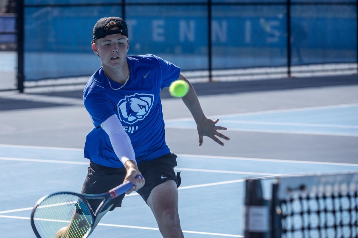 Freshman tennis player Ludolph Wiggett tries to hit the ball during the Eastern Illinois Fall Invitational Friday at the Darling Courts. 