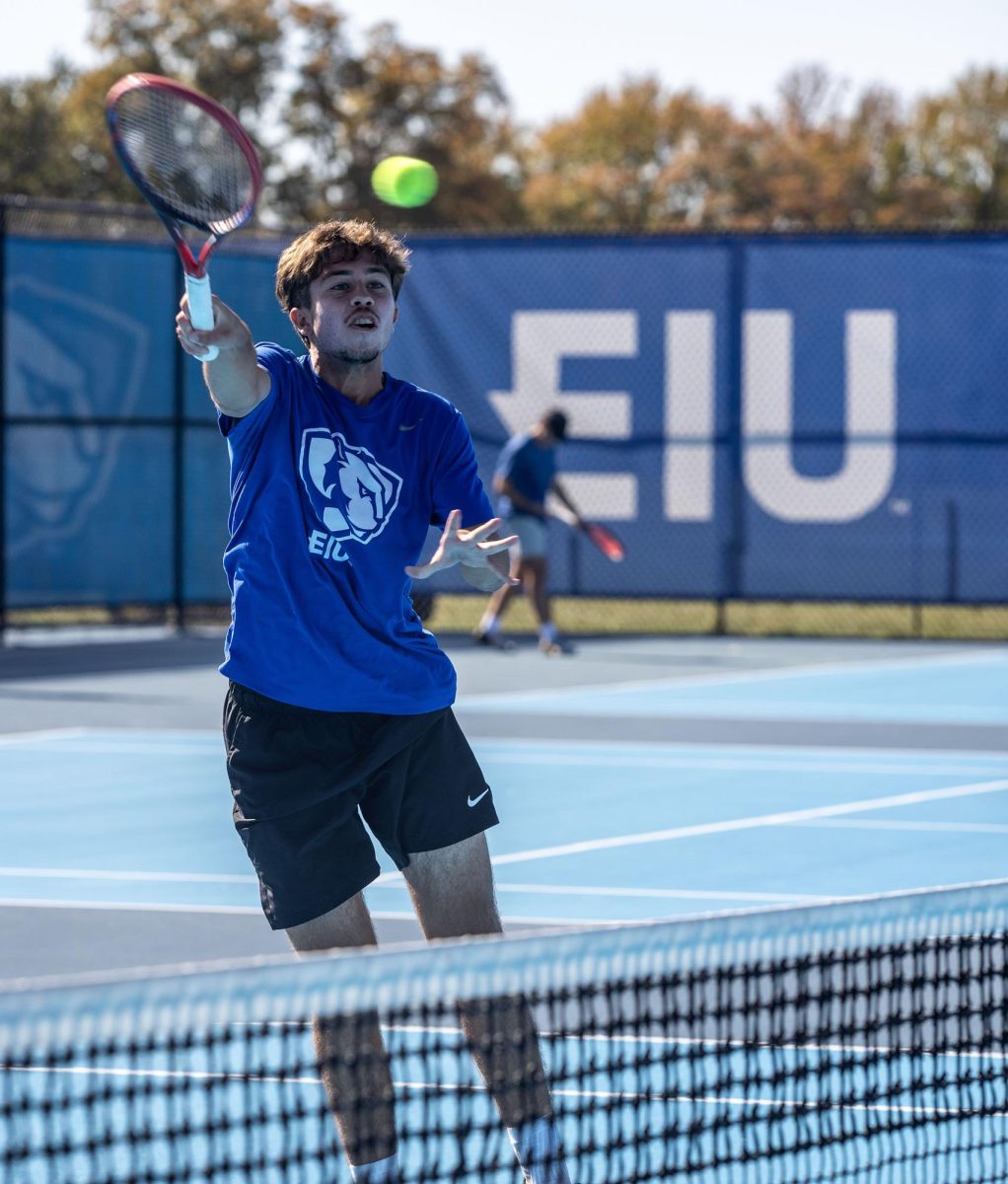 Freshman Durante Trocado smashes the ball during a doubles match with Ludolph Wiggett for the Eastern Illinois Fall Invitational Friday at the Darling Courts. 