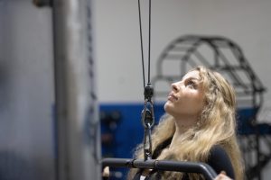 Monica Alifantis, a junior public relations major, does lateral pull downs in the student recreation center in Groniger Arena Sept. 13.