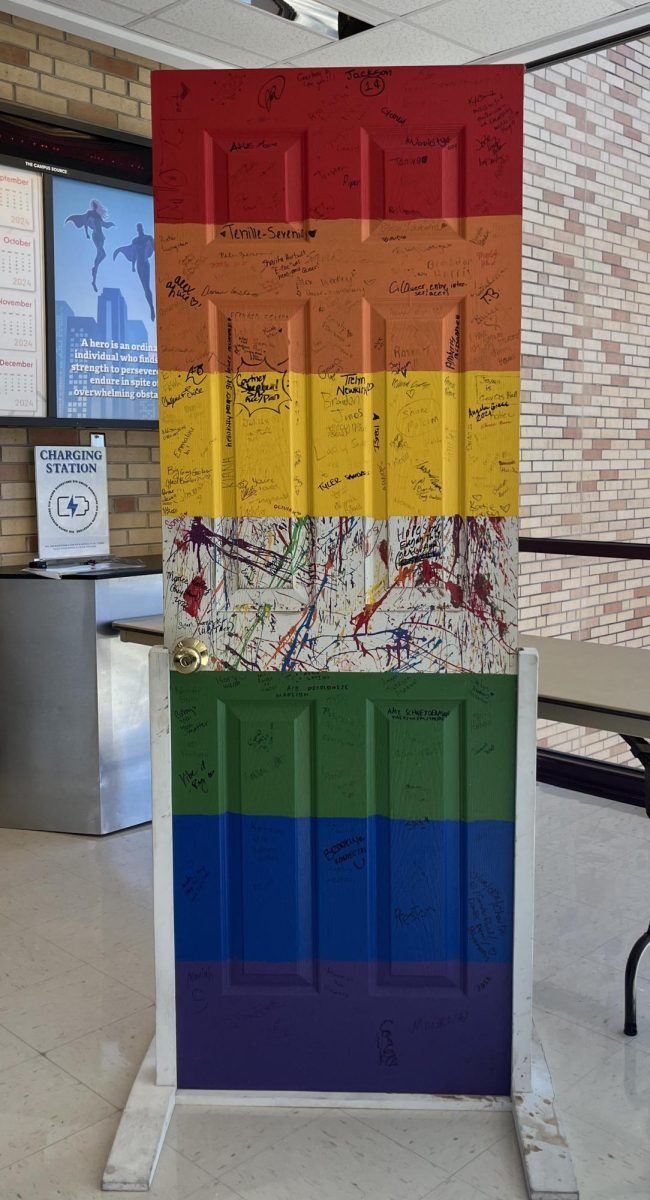 A rainbow painted door covered with signatures from EIU students showing their pride was showcased in the Bridge Lounge Tuesday. 