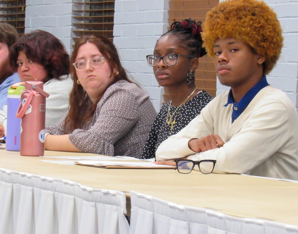 Freshman accounting major Justin Ambrose (right) was sworn into the Student Seante at its weekly meeting on Wednesday in the Tuscola-Arcola room of the MLK student union. 