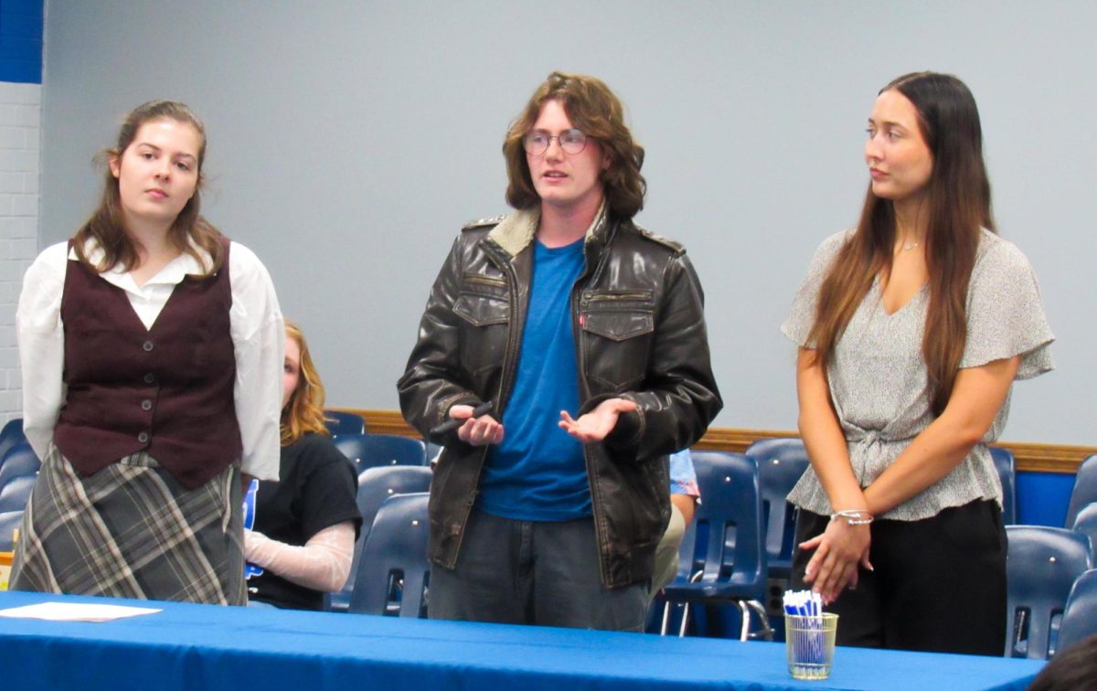 The executive board of the Tarble student advisory committee, including juniors secretary Carli Keller (left), president James Haddon (middle) and vice president Ellie Yates (right), present to the student government in the Tuscola-Arcola room of the MLK Student Union on Wednesday.