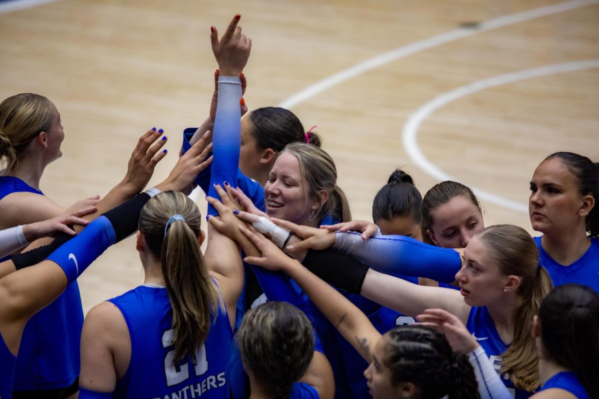 Head Volleyball Coach Cheers with the Volleyball team with a smile on her face ready for the next play, during the Eastern Illinois University against Southern Illinois University Evansville, on Tuesday Oct 15. 2024. at Groniger Arena on the Eastern Illinois University campus.  
