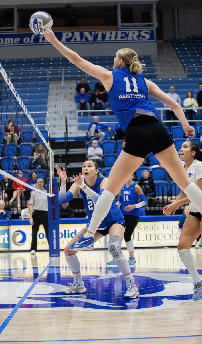 Senior outside hitter Kaitlyn Flynn taps the ball over the net during the Eastern Illinois University against Southern Illinois University Evansville.