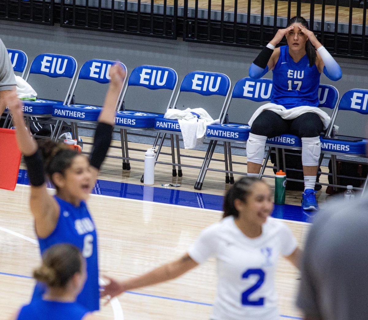 Sophomore Middle blocker Julia Stanev sits on the side lines looking stressed with her hands to her head, during the Eastern Illinois University against Southern Illinois University Evansville