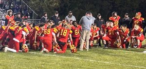 Charleston head coach Brian Halsey talks to his team following the Trojan's 35-23 loss to Taylorville on Friday, October 18, 2024, at Trojan Hill.