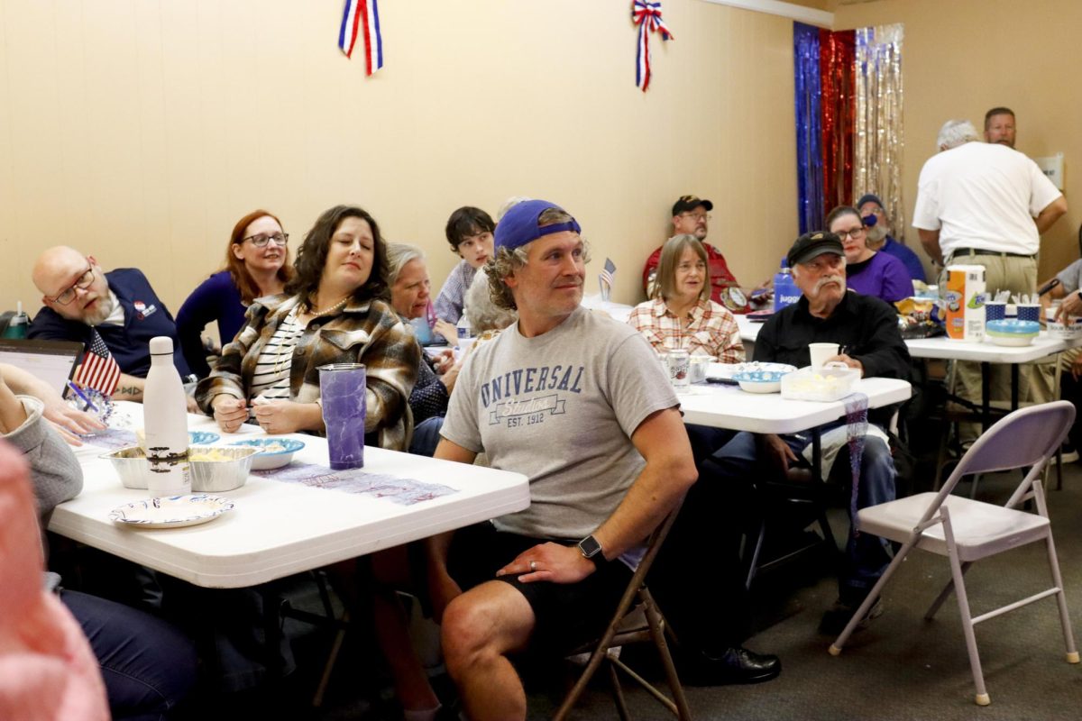 Democratic watch party goers all watch attentively as the 2024 elections results start to come in at the Coles County Democrat headquarters during its watch party of the 2024 election Tuesday night.