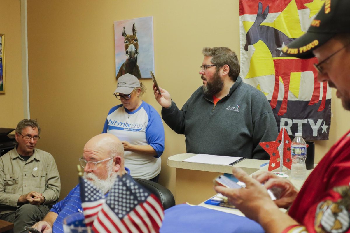 From right, Bill McGarth, Mack White, Jenifer White, Matt Titus and and County Board #6 democratic representative Doug Fagan all check the poll results for the County Board candidates at the Close county Democratic Party head quarters during its watch party of the 2024 election Tuesday, November 5, 2024. (© Alexis Moore Jones 2024)