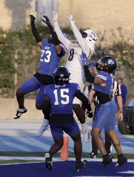 Freshman defensive back Isaiah Houi (23) and senior tight end Brandon Lanier go up for the ball in the final minute of the game