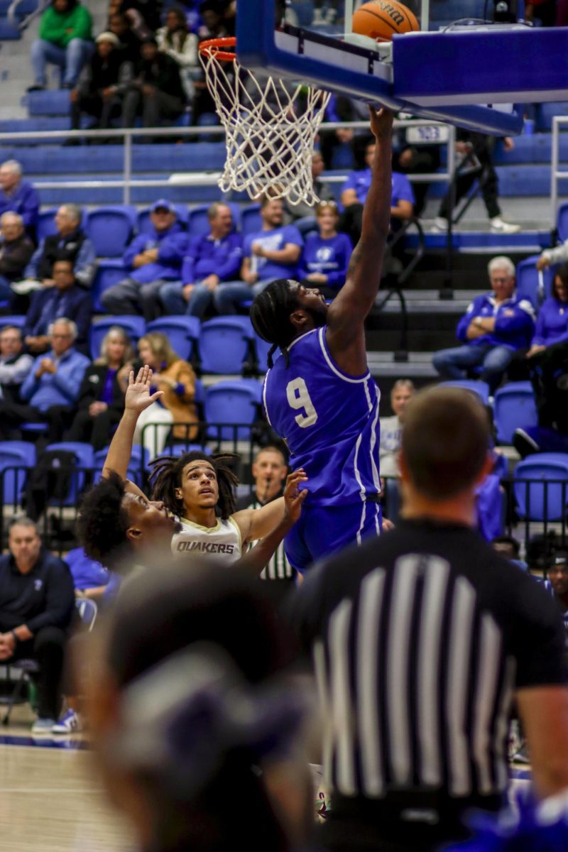 Redshirt junior guard Obadiah Curtis try to make a jump shot and misses the net, during The Eastern Illinois University against Earlham Quakers men basketball game at Groniger Arena,