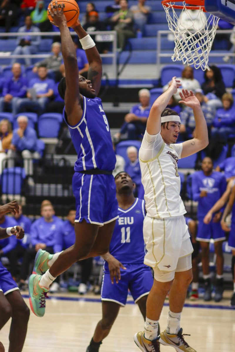 Redshirt junior guard Obadiah Curtis try to make a jump shot and makes it in with a dunk shot, during The Eastern Illinois University against Earlham Quakers 