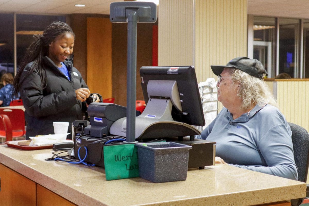 Junior nursing major Mikeya Carbins checks out and talks to Mary Kaiser Stevenson Tower Deli.