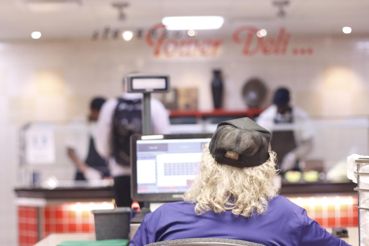 Mary Kaiser sits at the register inside of Stevenson Tower Deli waiting for students to check out 