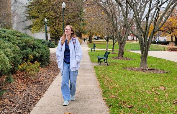 Sophomore English education major Faith Gallagher walks on campus next to Booth Library while admiring the fall colors and weather on her way to her next class.