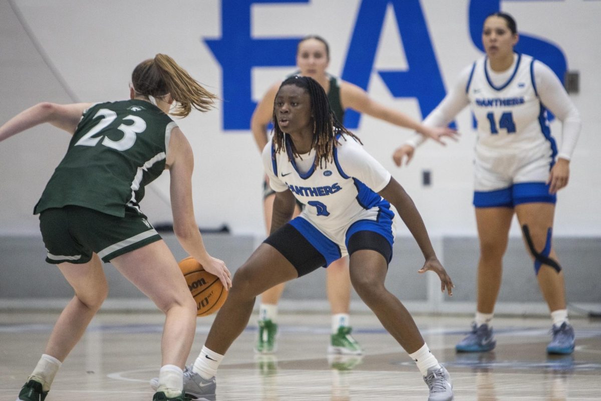 EIU sophomore guard Lalani Ellis defends senior guard Illinois Wesleyan University Mallory Powers during the second quarter of Eastern's win against IWU 70-67 on Monday in Groniger Arena.