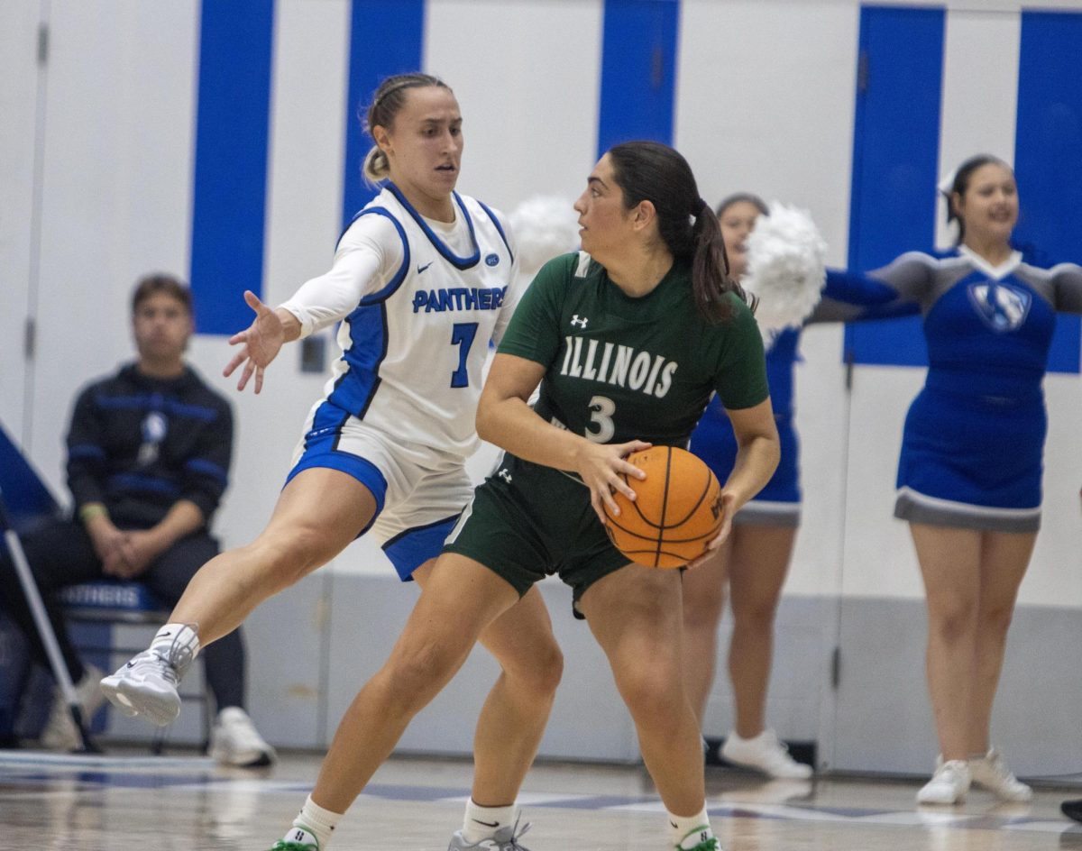 EIU guard Kiyley Flowers defends Illinois Wesleyan junior guard Sara Balli during the second quarter of Eastern’s women's basketball exhibition match against Illinois Wesleyan at Groniger Arena Monday.