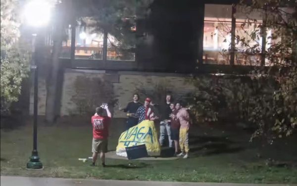 Students pose in front of EIU Spirit Rock with political statement "MAGA 47" at Eastern Illinois University in Charleston, Ill.