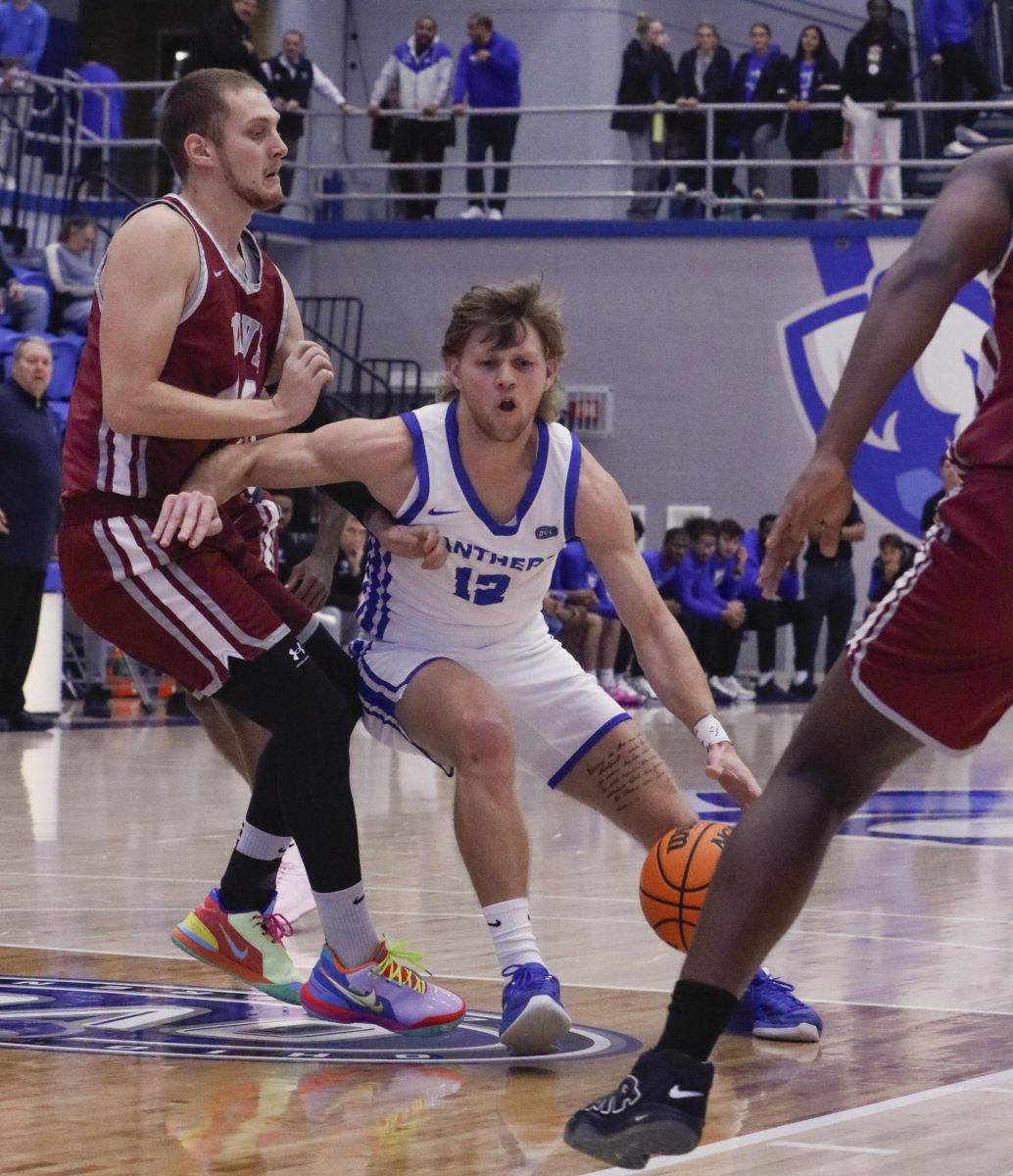 Eastern Illinois senior guard Carson Prost drives into the lane before passing the ball to the corner during the first half of Eastern’s kids day game against Calumet Saint Joseph at Groniger Arena in Charleston Ill.