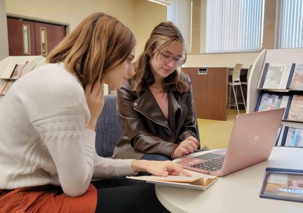 Junior English language arts majors Josie Moore (left) and Kathryn Lanham (Right) sit on the lounge room on the second floor of Booth Library studying for their English class.