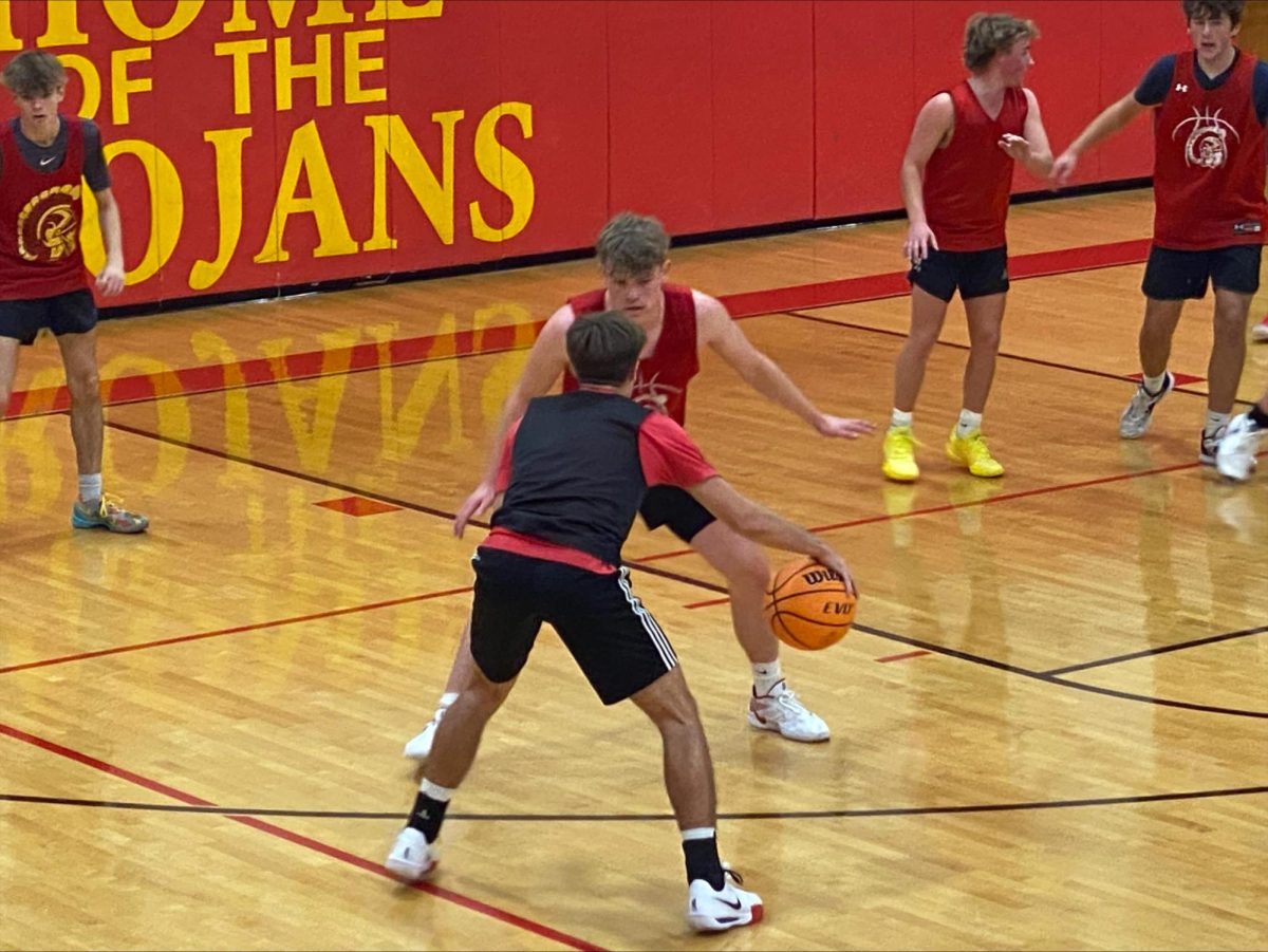 Senior guard Luke Bonnstetter dribbles the basketball as junior guard Tyler Oakley guards him in a Charleston boys basketball intrasquad scrimmage on November 30, 2024 at Baker Gym in Charleston, Illinois