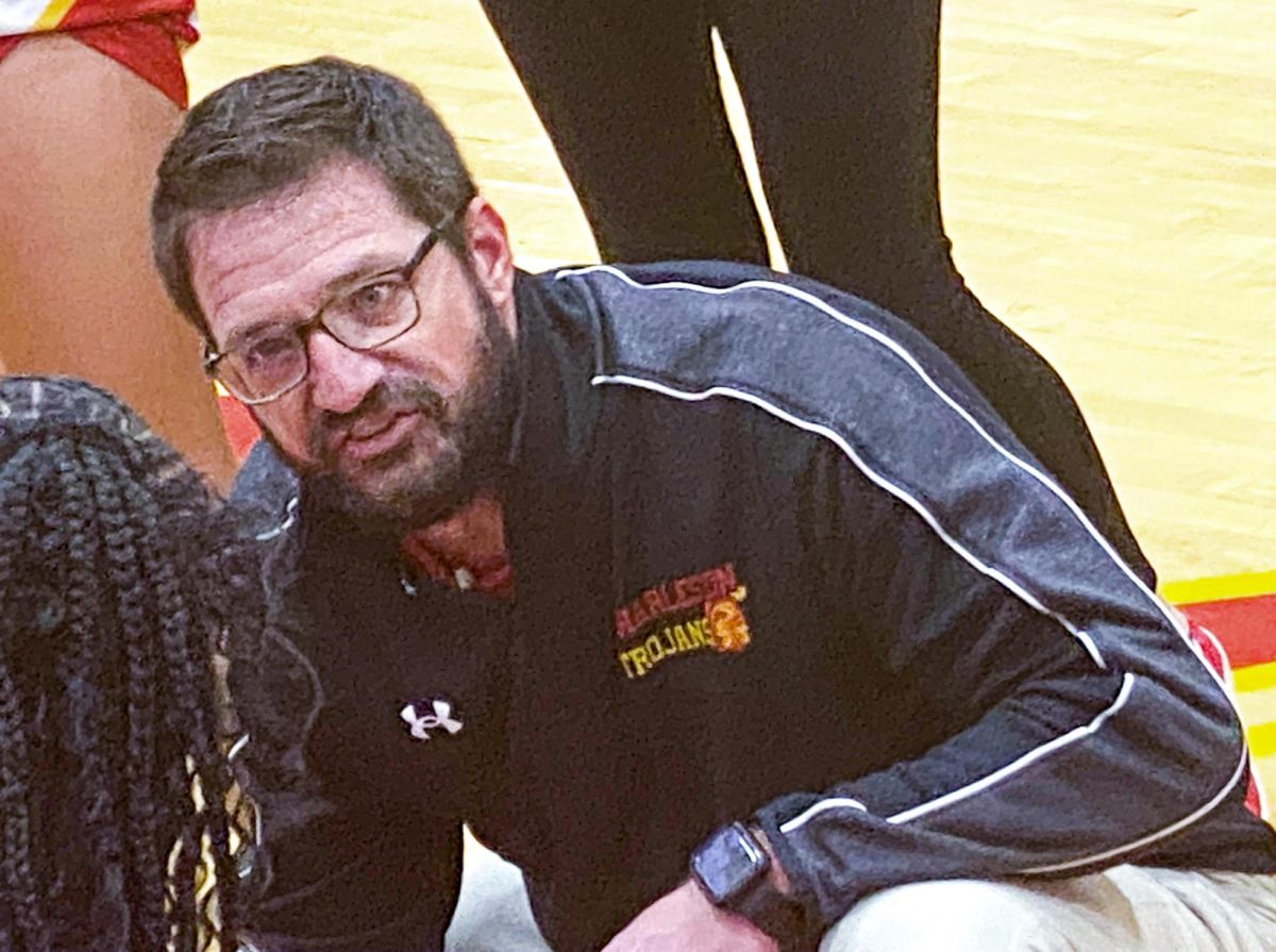 Charleston girls' basketball head coach Alex Koebele won his first Apollo Conference game as head coach of the Trojans with a 29-28 win over Mattoon Saturday evening at Baker Gym.