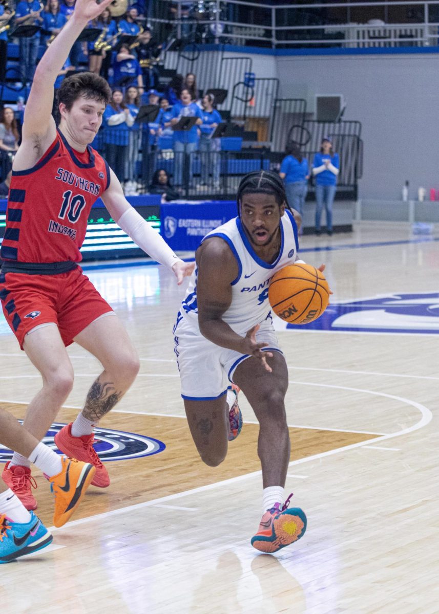 Redshirt junior guard Obadiah Curtis drives to the basket against Graduate student forward Jack Mielke during the second half of Eastern’s lost to Southern Indiana 64-60 on Saturday