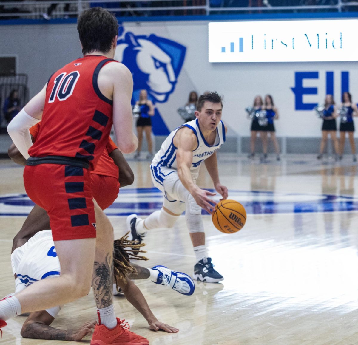 Graduate student Kooper Jacobi grabs the loose ball while Graduate student forward Jack Mielke runs over to guard him during the second half of Eastern’s lost to Southern Indiana 64-60 on Saturday.