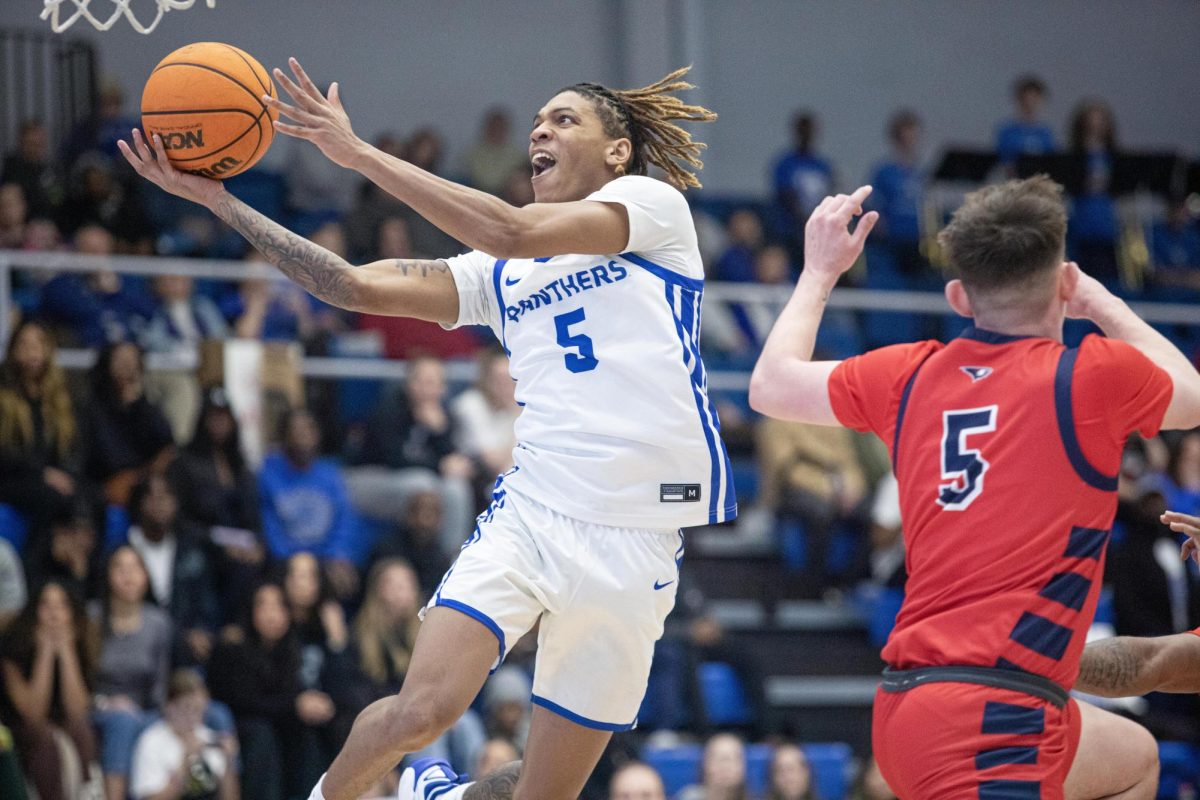 Junior guard Zion Fruster jumps past Junior guard Jack Campion on his way to the basket for a layup during the second half of Eastern’s lost to Southern Indiana 64-60 on Saturday.