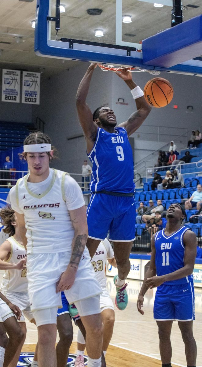 (Thumbnail Edition) Redshirt junior guard Obadiah Curtis try to make a jump shot and makes it in with a dunk shot, during The Eastern Illinois University against Earlham Quakers 