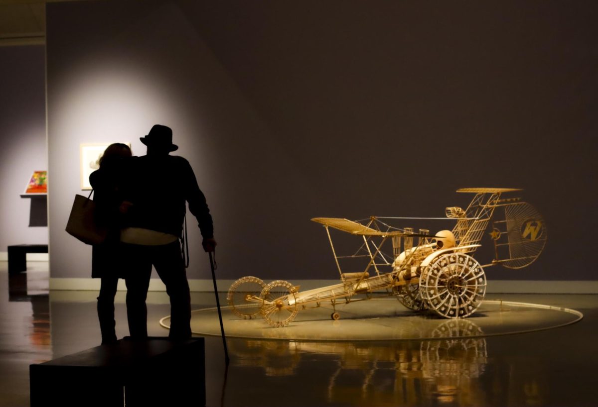 Andrea Leege and Jerry Ittamore observe the work of late EIU art professor Carl Wilen Friday in the Tarble Arts Center.