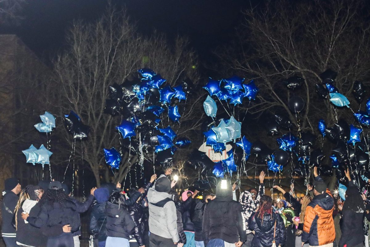 Students release balloons outside the Lawson basketball courts Saturday for Yahacov Dennis.