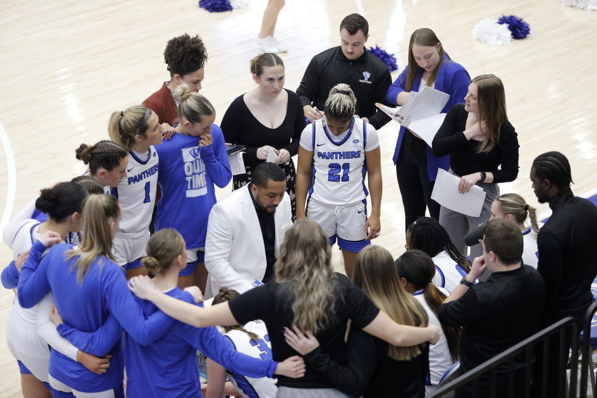 EIU women's basketball head coach Marqus McGlothan instructs players during a timeout during the women's basketball game against University of Southern Indiana at Groniger Arena Saturday. The Panthers won 51-49 in a late game layup and free throw with 13 seconds left allowing the Panthers to continue on a 10-0 win streak in the Ohio Valley Conference. 