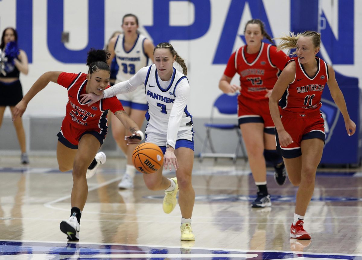 Southern Indiana University sophomore forward Amiyah Buchanan and EIU senior guard Kiyley Flowers grab for a loose ball during the women's basketball game against USI at Groniger Arena Saturday. Flowers scored four points. Buchanan scored one point and had four rebounds. The Panthers won 51-49 in a late game layup and free throw with 13 seconds left allowing the Panthers to continue on a 10-0 win streak in the Ohio Valley Conference.  