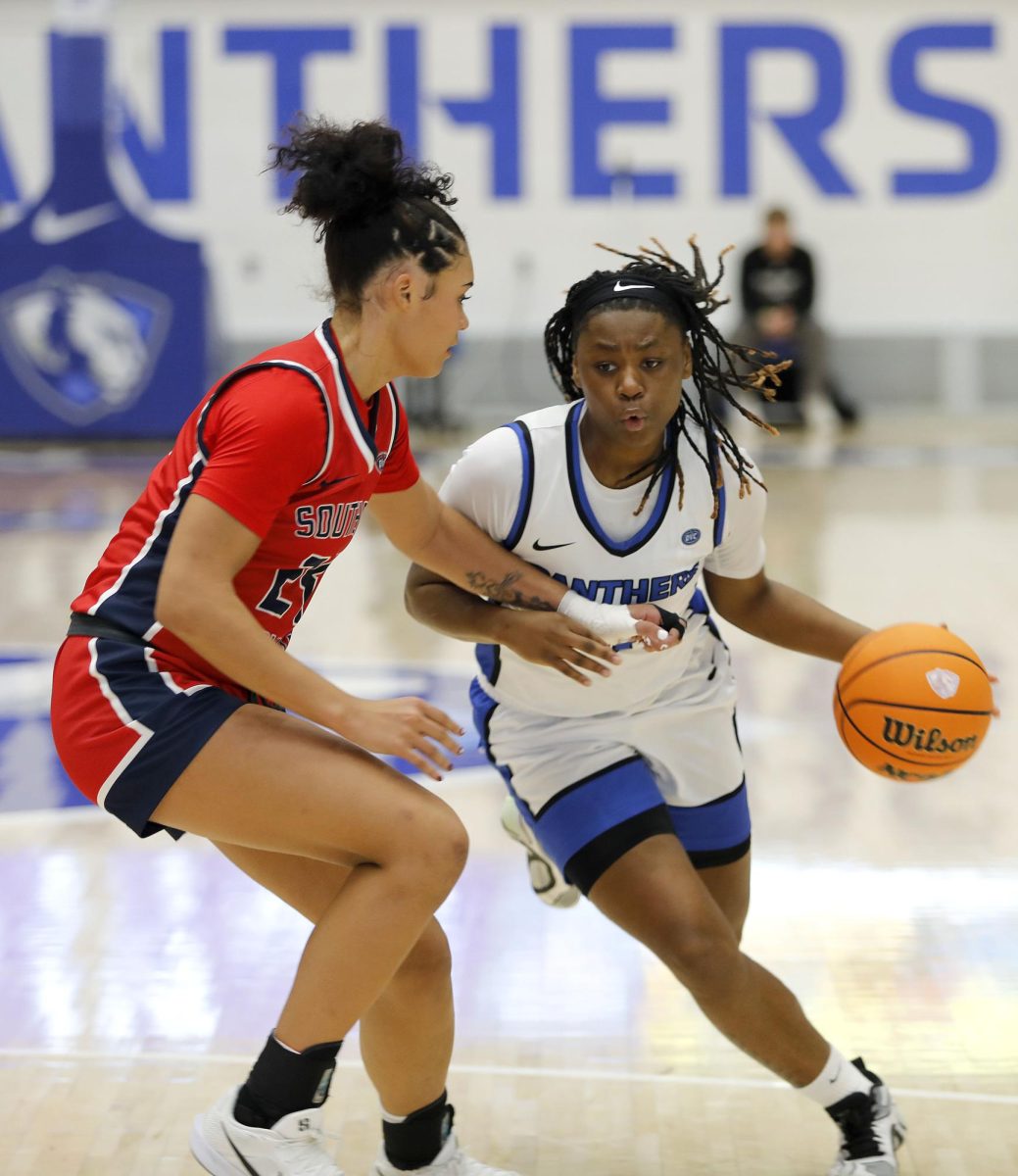 EIU sophomore guard Lalani Ellis (0) pushes past the Screaming Eagles to score a layup during the last 15 seconds of the game putting EIU in the lead 50-49 during the women's basketball game against University of Southern Indiana at Groniger Arena Saturday. Ellis scored eight points and had one rebound. The Panthers won 51-49 allowing them to continue on a 10-0 win streak in the Ohio Valley Conference.  