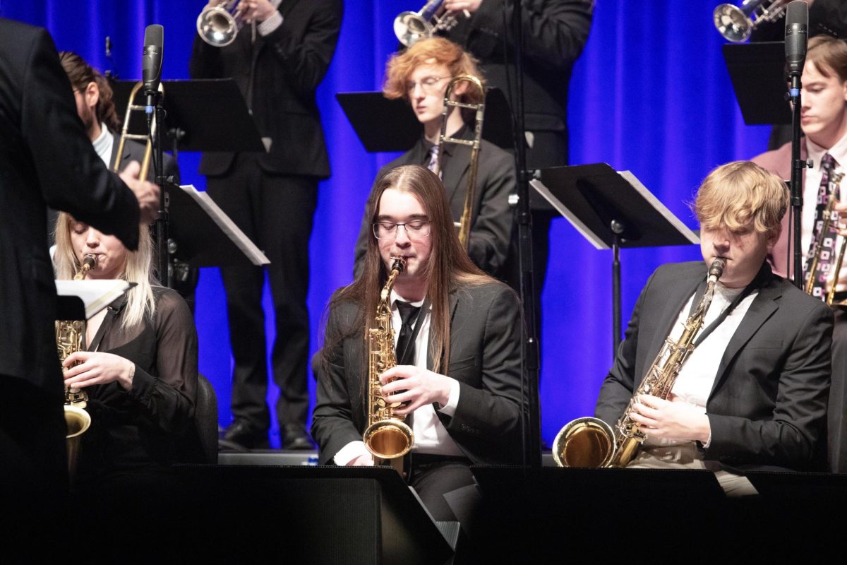 Saxophonists Kyle Rennier (Left) and Logan Webster (Right) play a jazz song during the first performance of the Eastern Jazz Festival.
