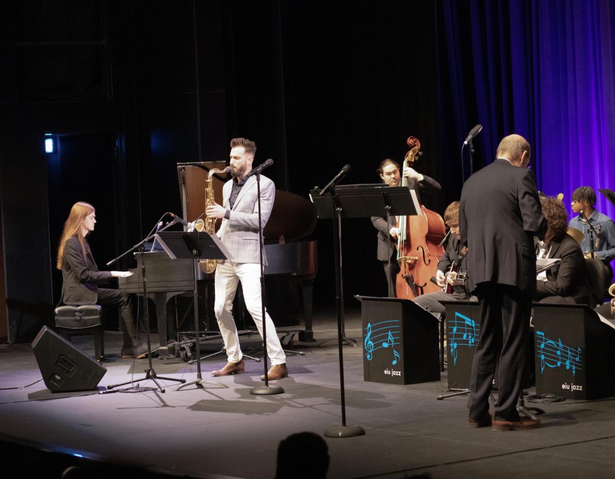Saxophonist Chad LB interacting with the rhythm section of the Eastern Illinois Jazz Ensemble during the first performance of the Eastern Jazz Festival in the Theatre in the Doudna Fine Arts Center on Friday.