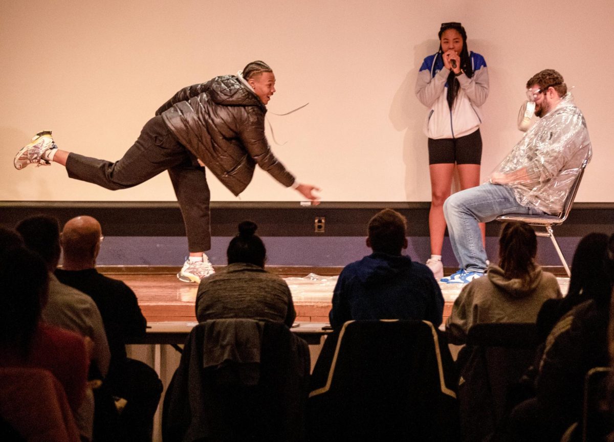 Redshirt junior running back Jay Pearson throws a cream pie into the face of a faculty member in the Grand Ballroom in the Martin Luther King Jr. Union.