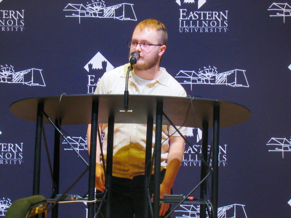 Graduate student Riley Bauer reads his creative nonfiction work at the Lions in Winter Festival in the Dvorak Concert Hall on Thursday.