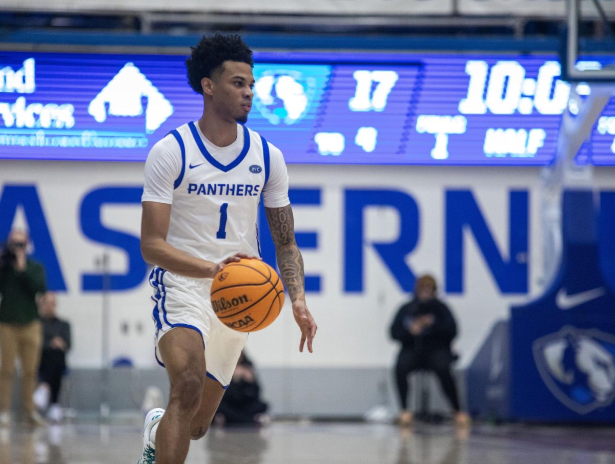 Eastern senior guard Corey Sawyer Jr brings the ball up past the half court line during the first half Eastern basketball’s win against Little Rock 71-60 at Groniger Arena on Thursday.