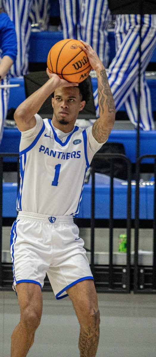 Eastern senior guard Corey Sawyer Jr goes up for a three-point shot during the first half Eastern basketball’s win against Little Rock 71-60 at Groniger Arena on Thursday.