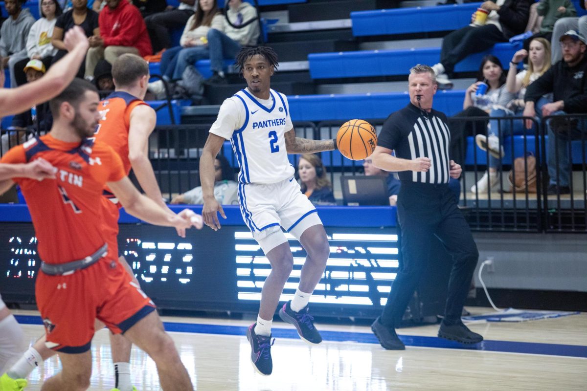 Graduate student guard Artese Stapleton jumps in the air as he dribbles the ball around the perimeter looking for an open shot in the first half during Eastern’s loss to UT Martin 72-68 on Saturday.