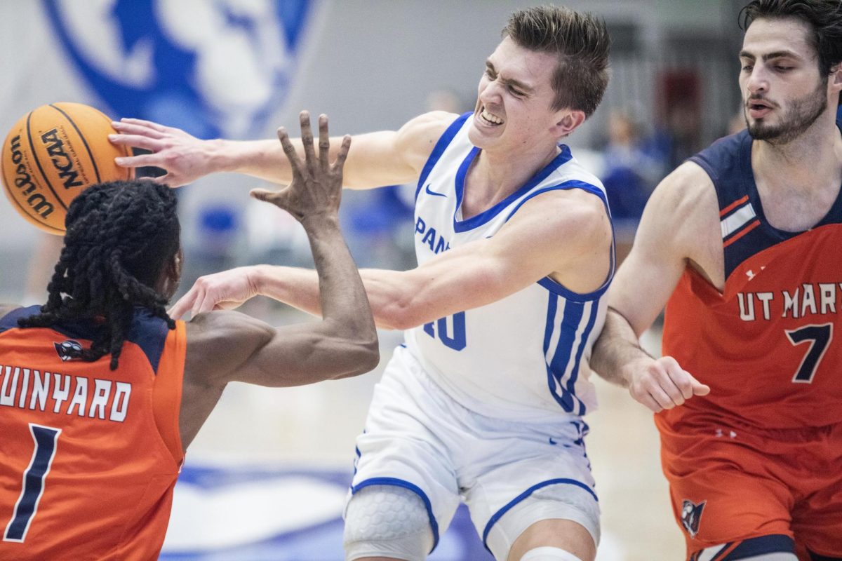 Graduate student forward Kooper Jacobi passes the ball as he is doubled team in the first half during Eastern’s loss to UT Martin 72-68 on Saturday.