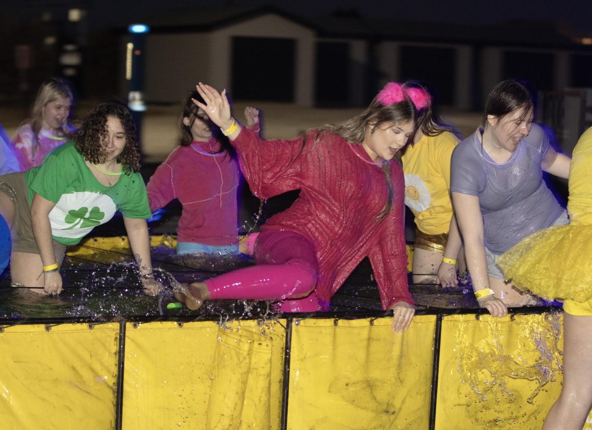 Alpha Sigma Alpha Gamma Omega members maneuvers through the freezing-cold Polar Plunge pool at the 2025 EIU Glow Plunge on Sunday, Feb. 23.