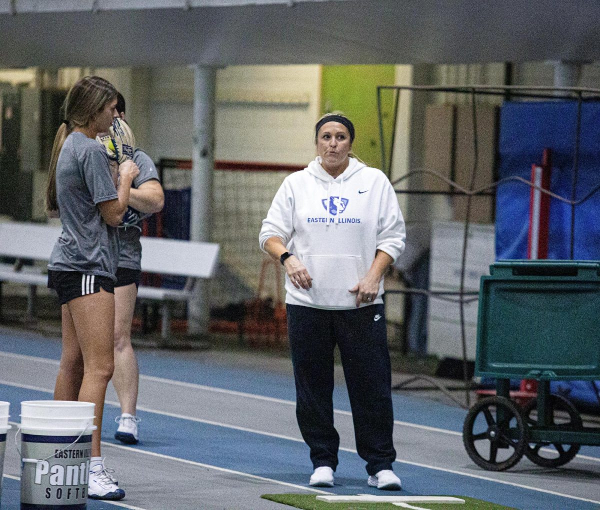 Softball Head Coach Kristi Paulson talks with junior pitcher Karlie McKenzie while working on pitch control at practice on Tuesday.