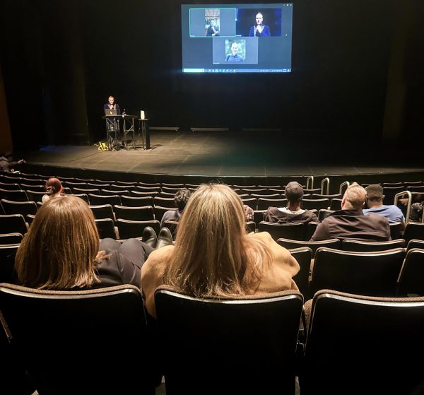 Professor in the Lumpkin college of business Evan Kubicek talks to owner of the NBA's Minnesota Timberwolves and billionaire entrepreneur Marc Lore over zoom call in-front of an audience of Eastern students and Charleston The Theatre on March 6.