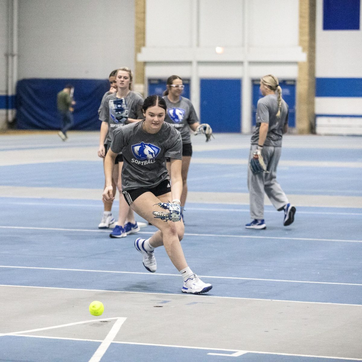Eastern Illinois softball freshman utility player Abbi Hatton fielding a ground ball in a fielding drill during softball practice at the field house in Groniger arena on Tuesday Feb. 11.