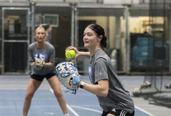 E[Thumbnail Edition] Eastern Illinois softball freshman utility player Abbi Hatton deciding to throw the softball to home plate in a fielding drill during softball practice at the field house in Groniger arena on Tuesday Feb. 11.