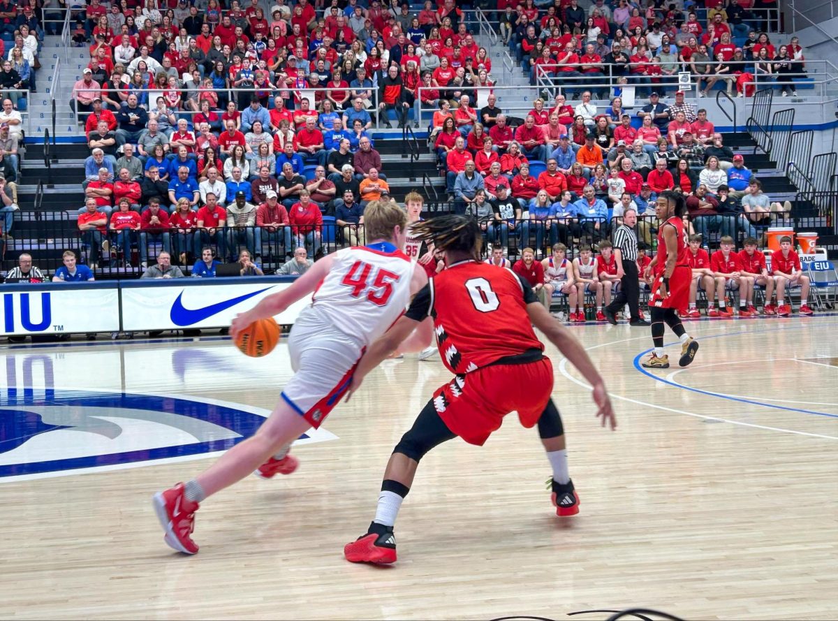 St. Anthony High School senior Brock Fearday dribbles past Meridian High School sophomore guard Latarus Johnson in the Illinois High School Association Class 1A Super sectional game at Groniger Arena on Monday.