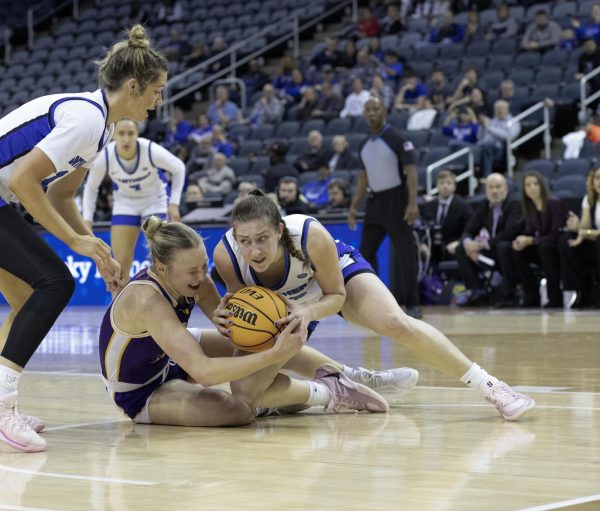 Senior Foward Macy McGlone gets pulled to the floor with the ball in hand, Eastern Illinois University lost to Western Illinois University Thursday March 6 20205, 78-75 EIU lost 