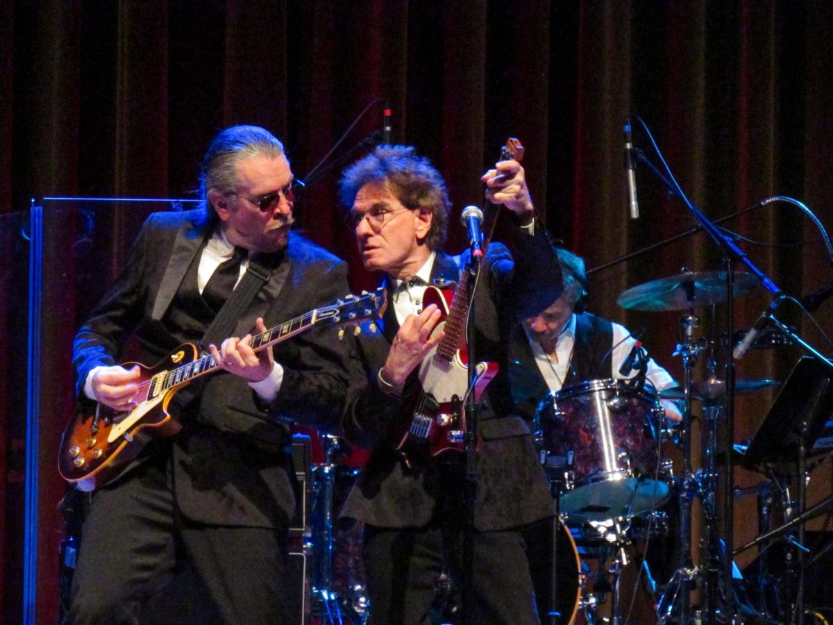 The Weeklings lead guitarist John Merjave [Left] and guitarist Bob Burger [Right] perform "I Am the Walrus" at The Weeklings Beatles Bash concert in the Dvorak Concert Hall on Saturday.